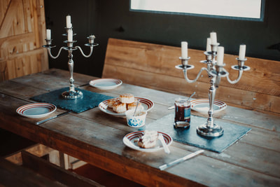 A rustic table adorned with plates and cups, creating a warm and inviting atmosphere for enjoying meals with loved ones.