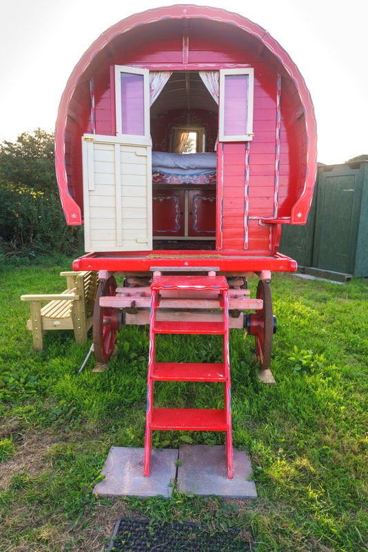 Step into Rosie, our delightful gypsy caravan! This red wagon offers a cozy bed inside, catering to both romantic escapes and family stays.